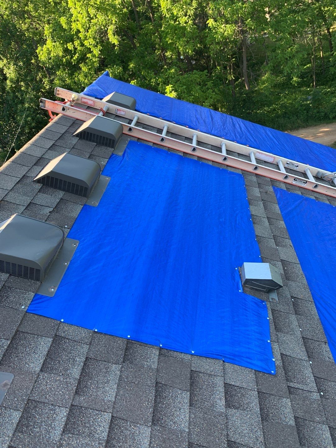 tarps and ladder on a roof