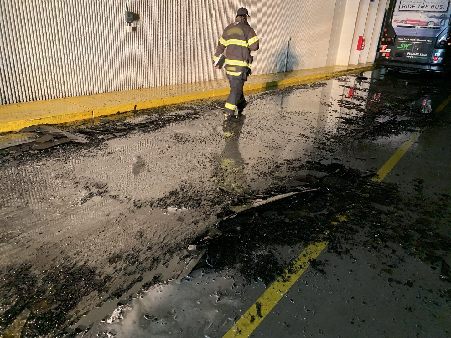 man walking in wet and soot covered garage