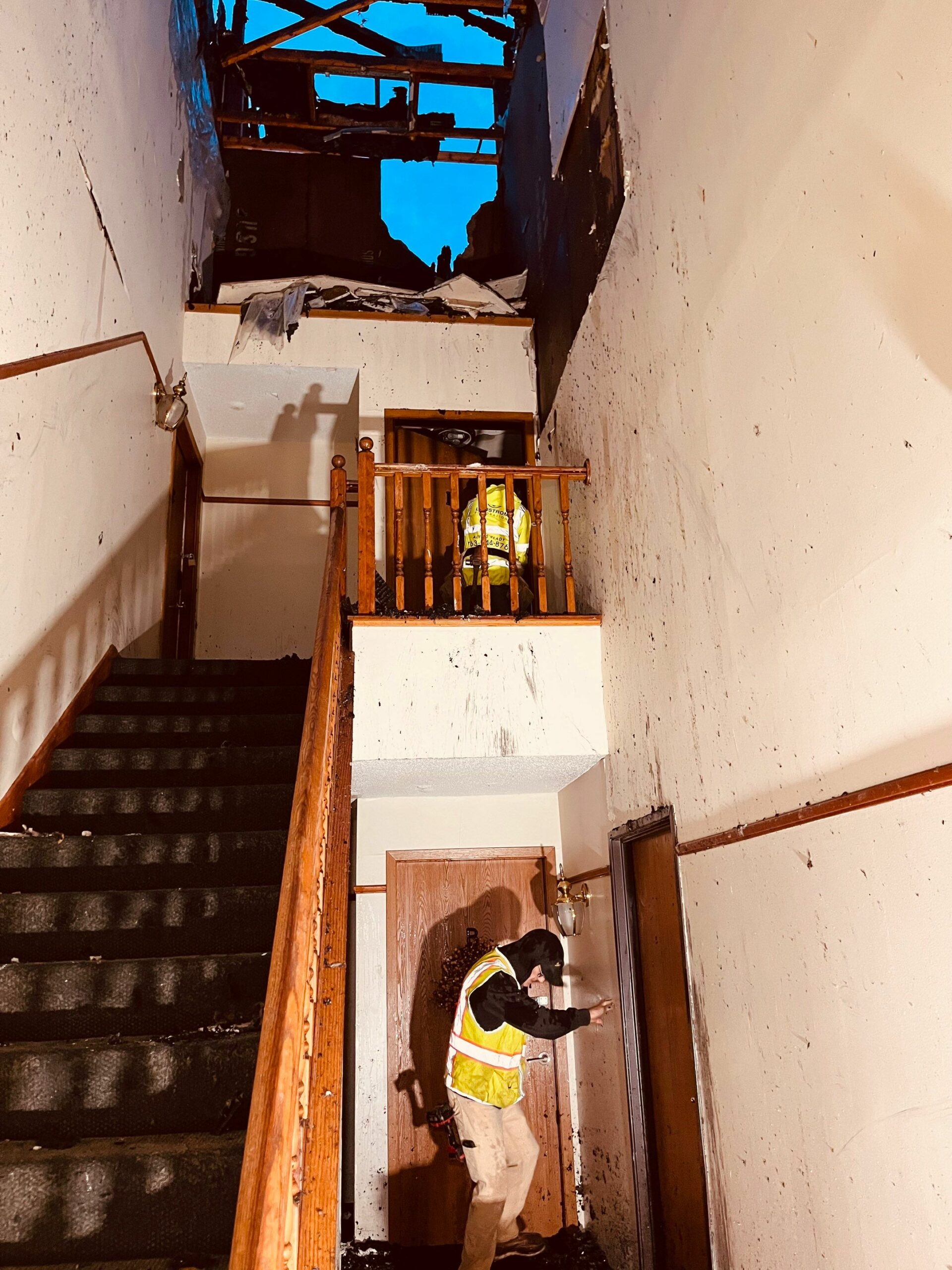 two men in damages hallway and stairwell