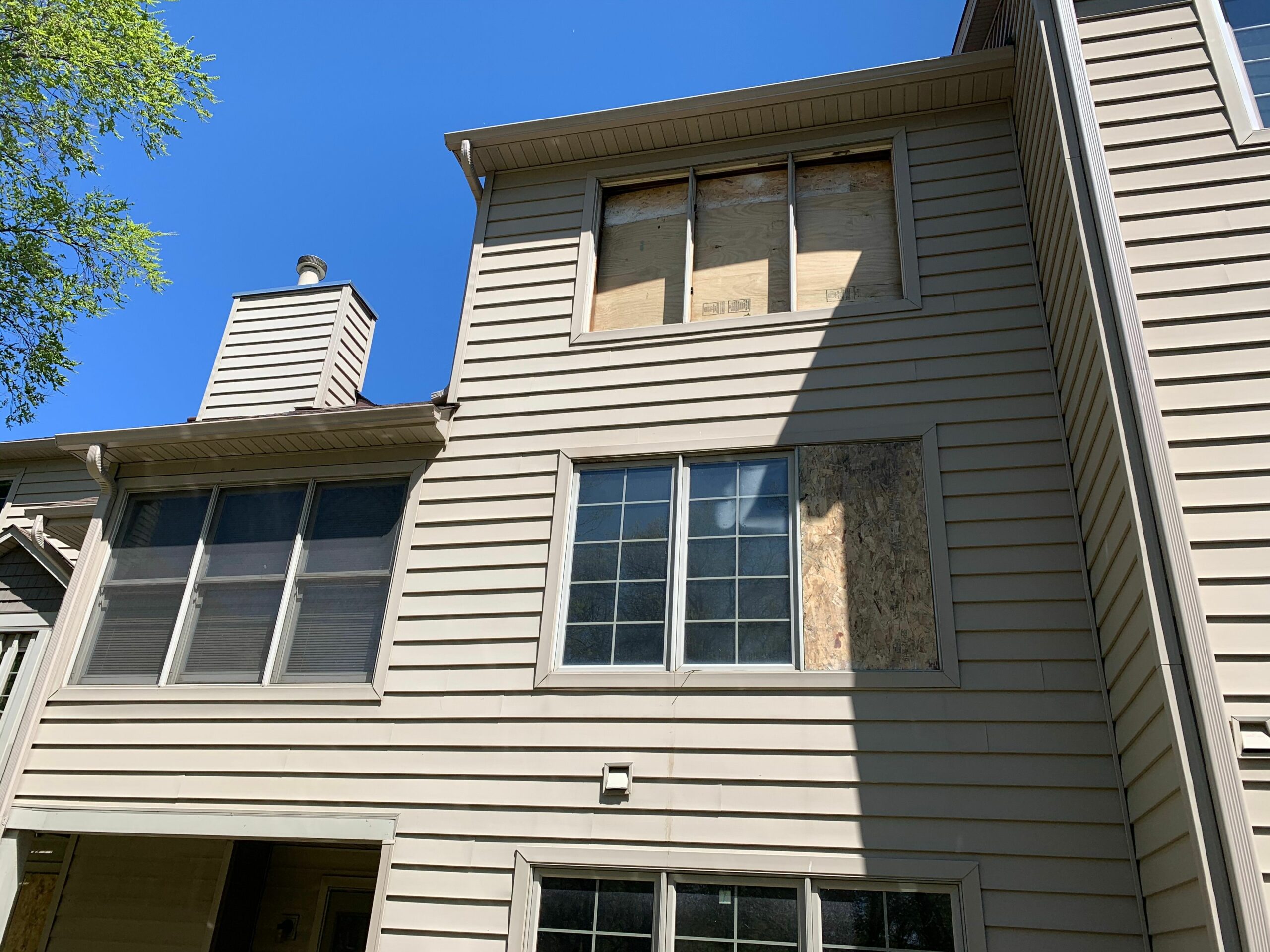 boarded up windows on a home