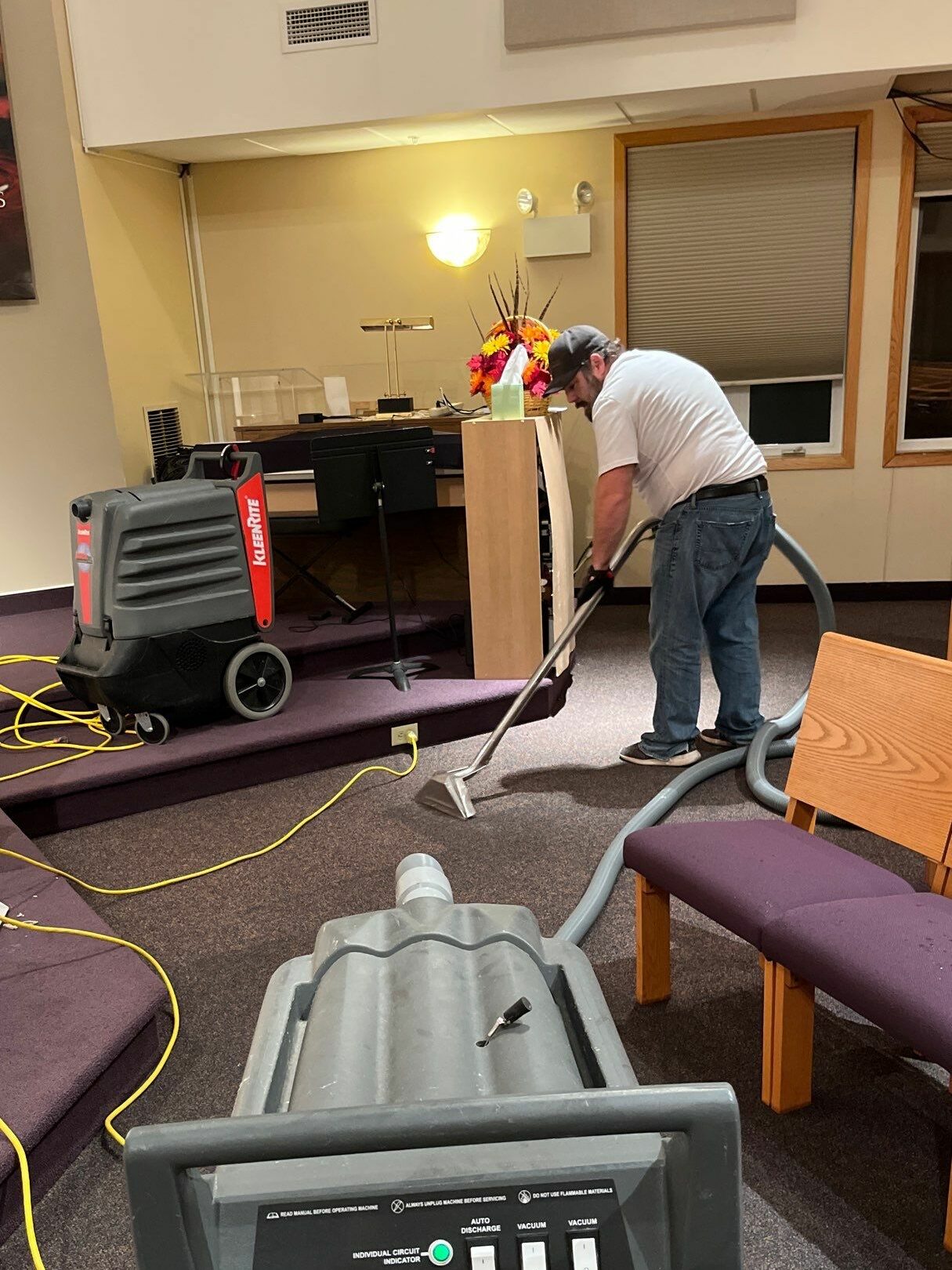 man cleaning wet carpeting